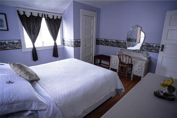 Burnside Suite - view of bed, window, and vanity